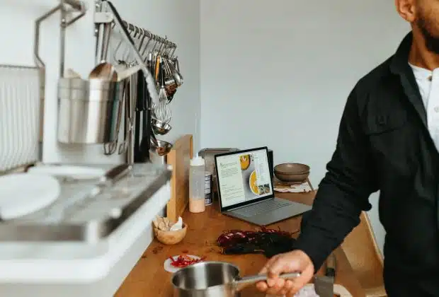 a man standing in a kitchen preparing food